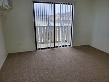 An empty living room with a sliding glass door